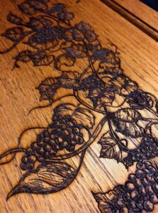 grape vine laser engraved on wood headboard Sacramento custom laser work Carmichael